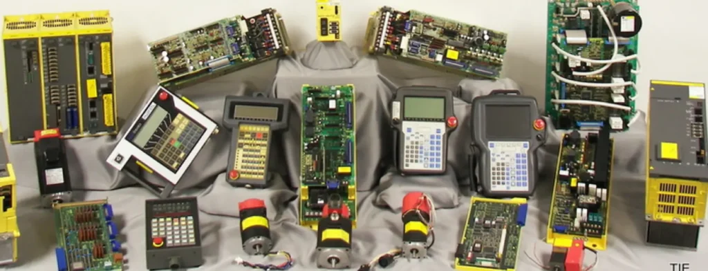 Assortment of refurbished robot controllers, teach pendants, and servo boards